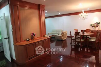 Elegant living and dining area with wooden flooring and chandelier lighting