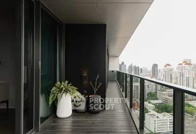 Modern high-rise balcony with stunning cityscape view and sleek design.