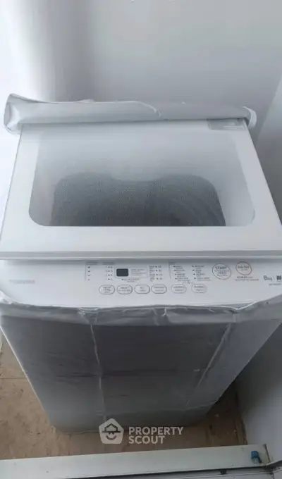 Modern washing machine in a sleek laundry area, perfect for efficient home living.
