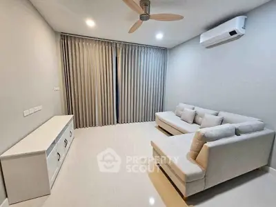 Modern living room with sleek furniture and air conditioning, perfect for relaxation.
