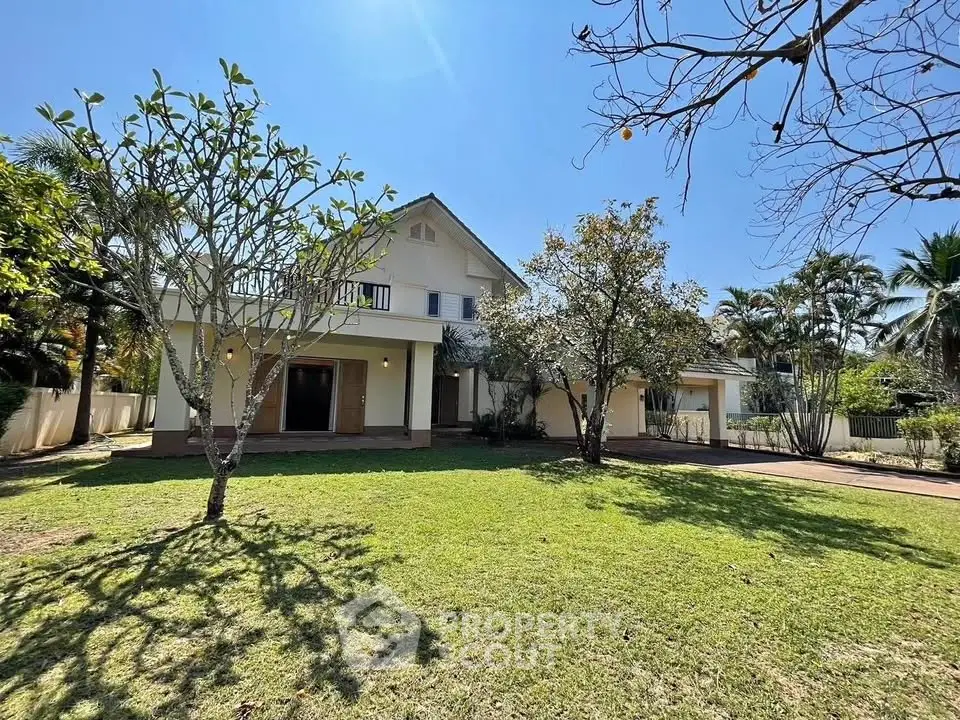 Charming suburban home with spacious front yard and lush greenery