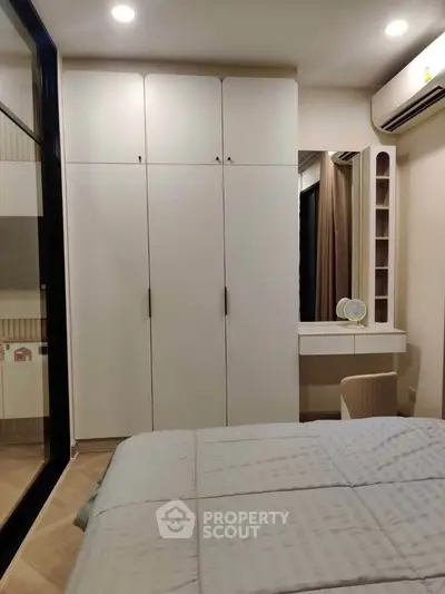 Modern bedroom with sleek wardrobe and cozy decor