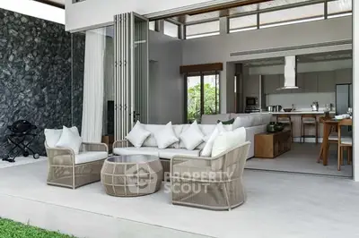 Luxurious open-plan living room with modern kitchen and outdoor seating area.
