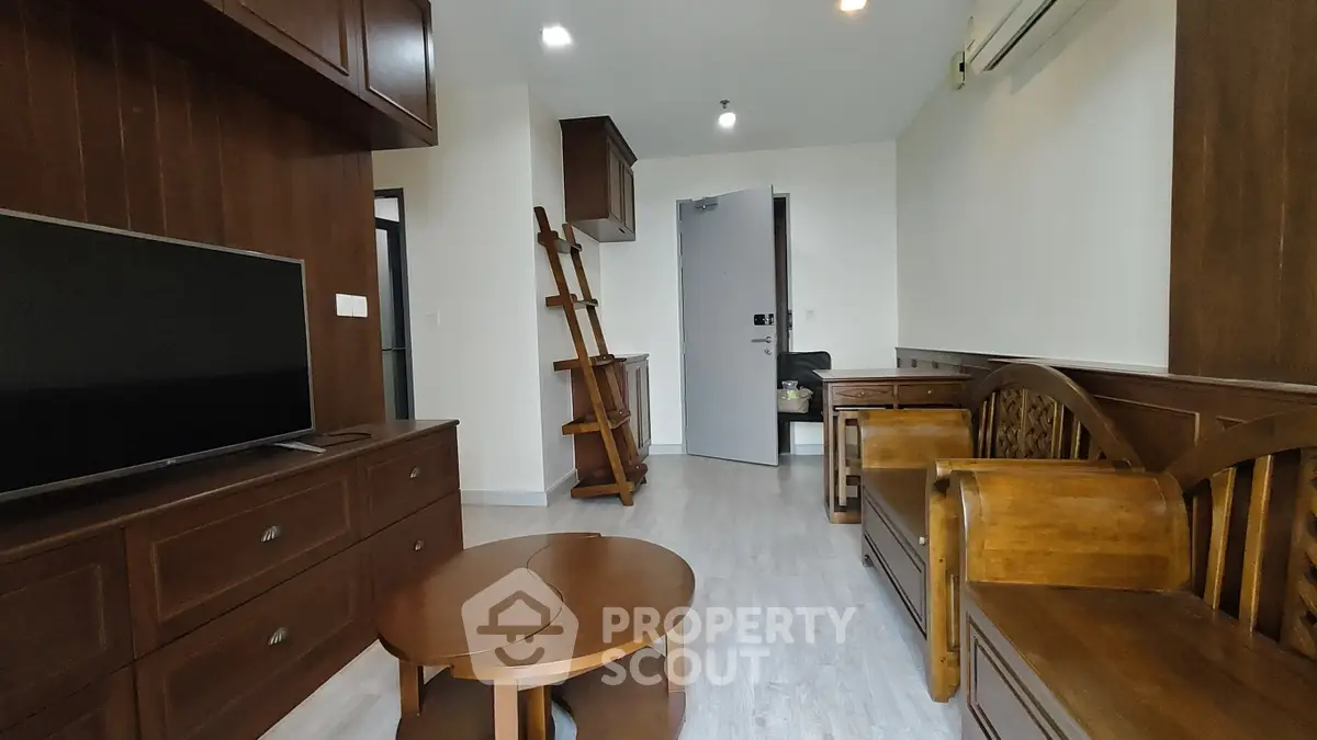 Charming living room with wooden furniture and modern decor in a cozy apartment.