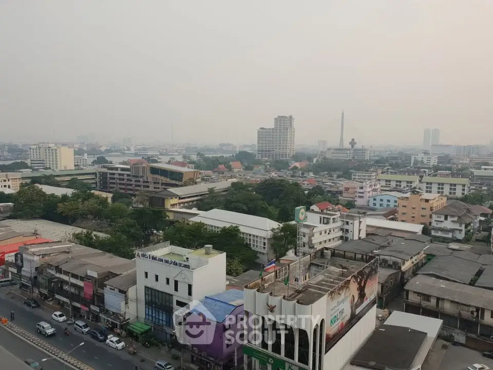 Panoramic cityscape view showcasing urban buildings and skyline from a high vantage point.