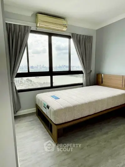 Modern bedroom with large window offering stunning city skyline view, featuring sleek flooring and air conditioning.