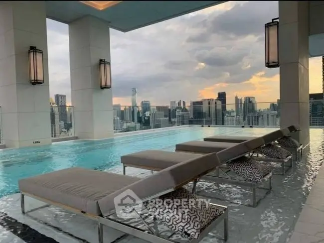 Luxurious rooftop pool with stunning city skyline views at sunset, featuring elegant lounge chairs.