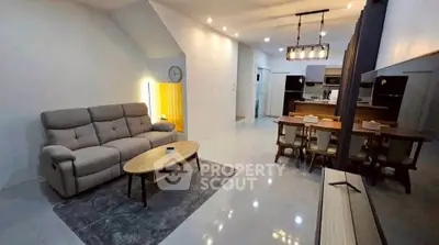 Spacious modern living room with open kitchen and stylish lighting