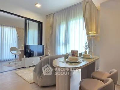 Modern living room with elegant decor and natural light, featuring a cozy dining area and stylish furnishings.