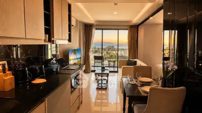 Luxurious open-plan living room with stunning sunset view and modern kitchen