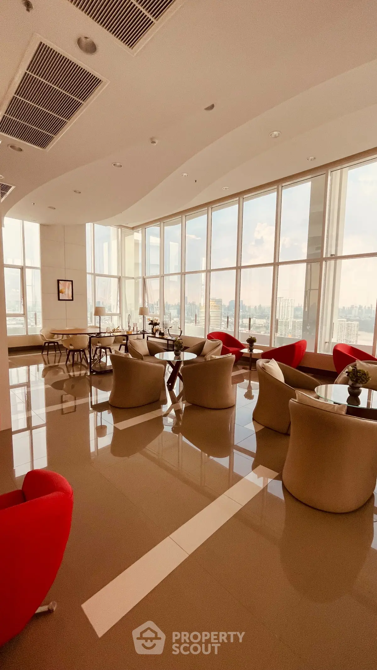 Luxurious high-rise building lounge with panoramic city views and modern seating.