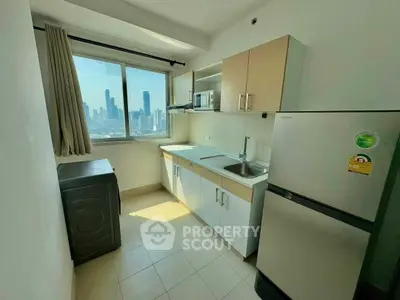 Modern kitchen with city view, featuring sleek cabinetry and appliances.