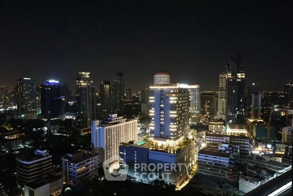 Stunning night view of a vibrant city skyline with illuminated buildings and urban landscape.