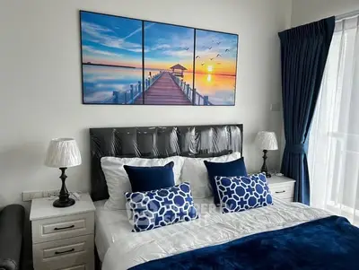 Luxurious bedroom with elegant decor and stunning wall art, featuring plush bedding and stylish bedside lamps.