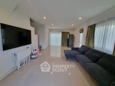 Spacious modern living room with sleek furniture and large windows