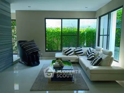 Modern living room with large windows and stylish furniture