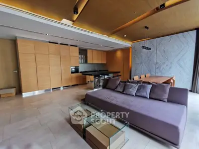Luxurious modern living room with sleek design and open kitchen layout, featuring elegant furniture and stylish decor.