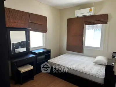 Cozy bedroom with air conditioning and stylish blinds, perfect for restful nights.