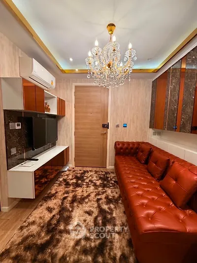 Luxurious living room with elegant chandelier and plush leather sofa