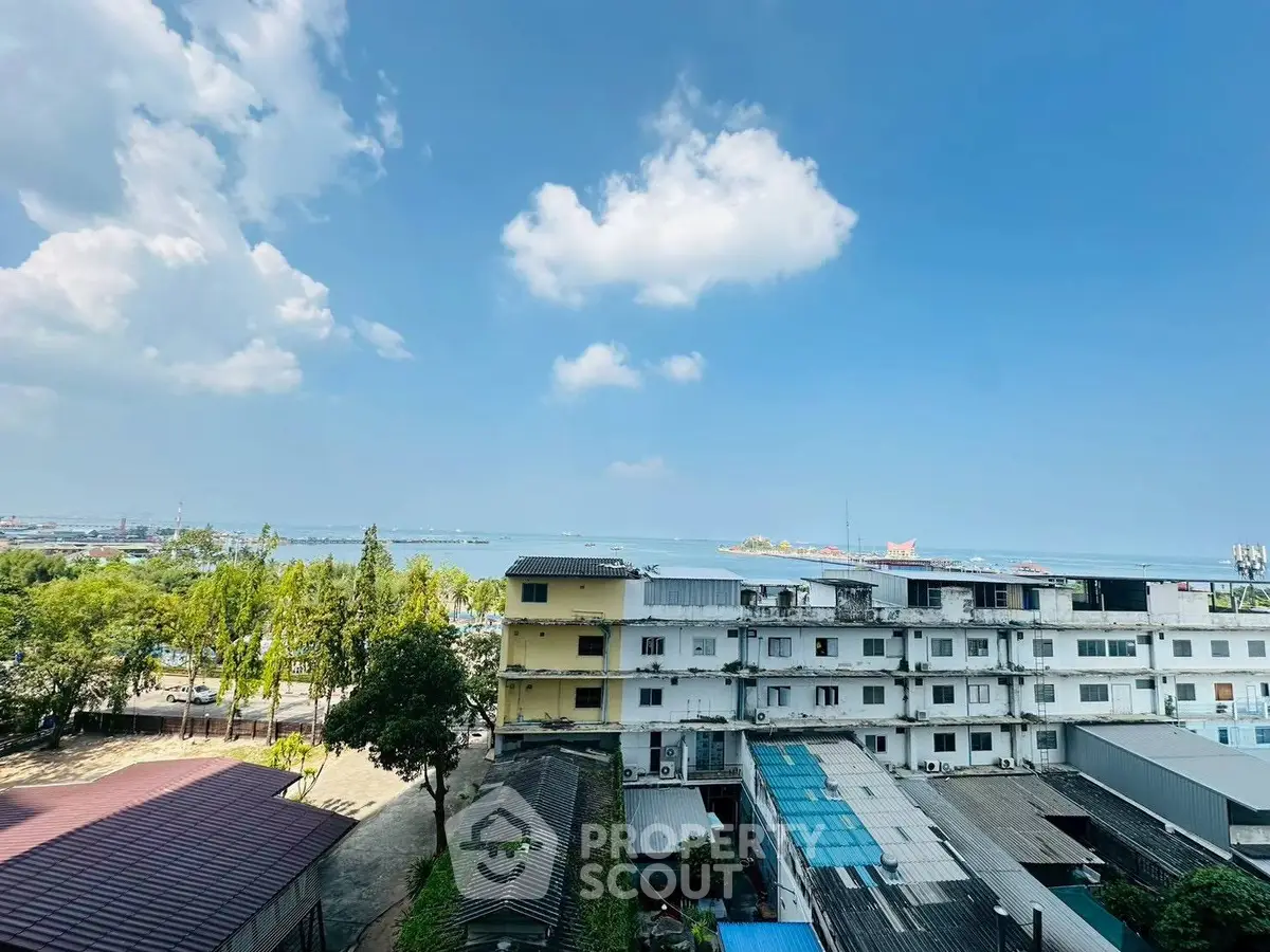 Stunning panoramic view from high-rise building overlooking cityscape and waterfront, perfect for urban living.