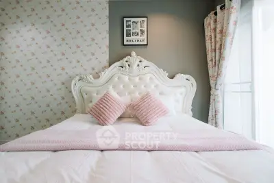 Elegant bedroom with ornate headboard and soft pink accents