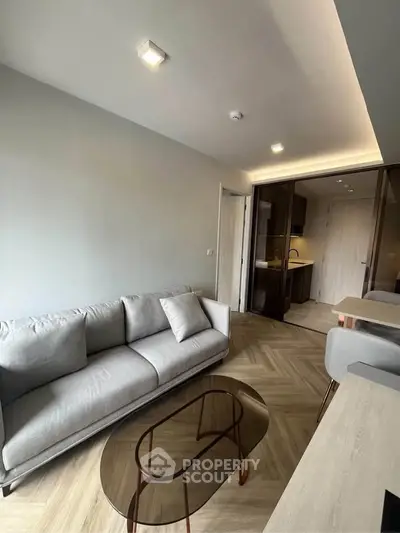 Modern living room with sleek furniture and open kitchen layout