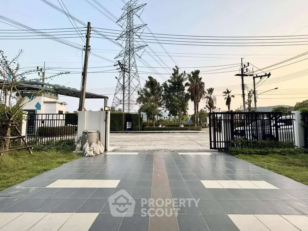 Spacious entrance with tiled flooring and gated access in serene neighborhood