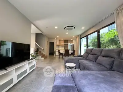 Spacious modern living room with large windows and stylish furniture