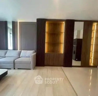 Modern living room with sleek wooden paneling and cozy sofa