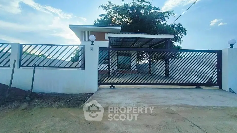 Modern house with gated entrance and spacious driveway