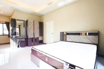 Spacious modern bedroom with sleek furniture and ample natural light