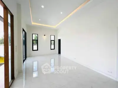 Spacious modern living room with high ceilings and large windows