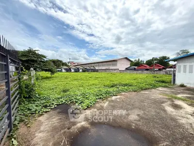 Spacious vacant land with lush greenery, perfect for development opportunities in a serene neighborhood.