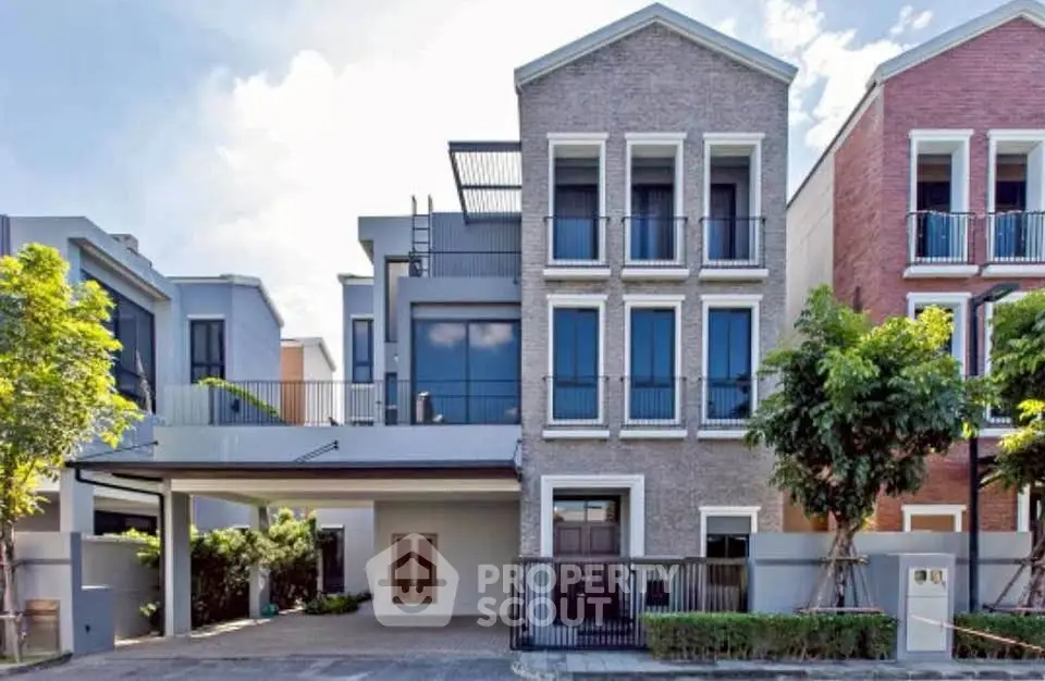 Modern three-story townhouse with brick facade and spacious driveway in a serene neighborhood.