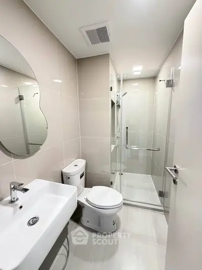 Modern bathroom with sleek fixtures and glass shower enclosure