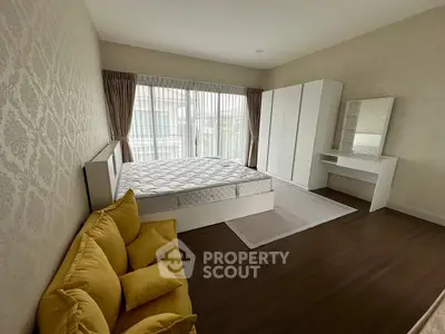 Spacious bedroom with large windows and elegant decor