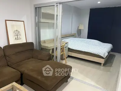 Modern studio apartment with cozy living area and comfortable bedroom