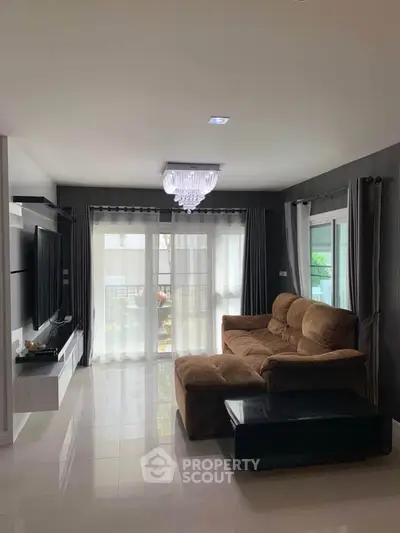 Spacious living room with modern decor and large windows for natural light.