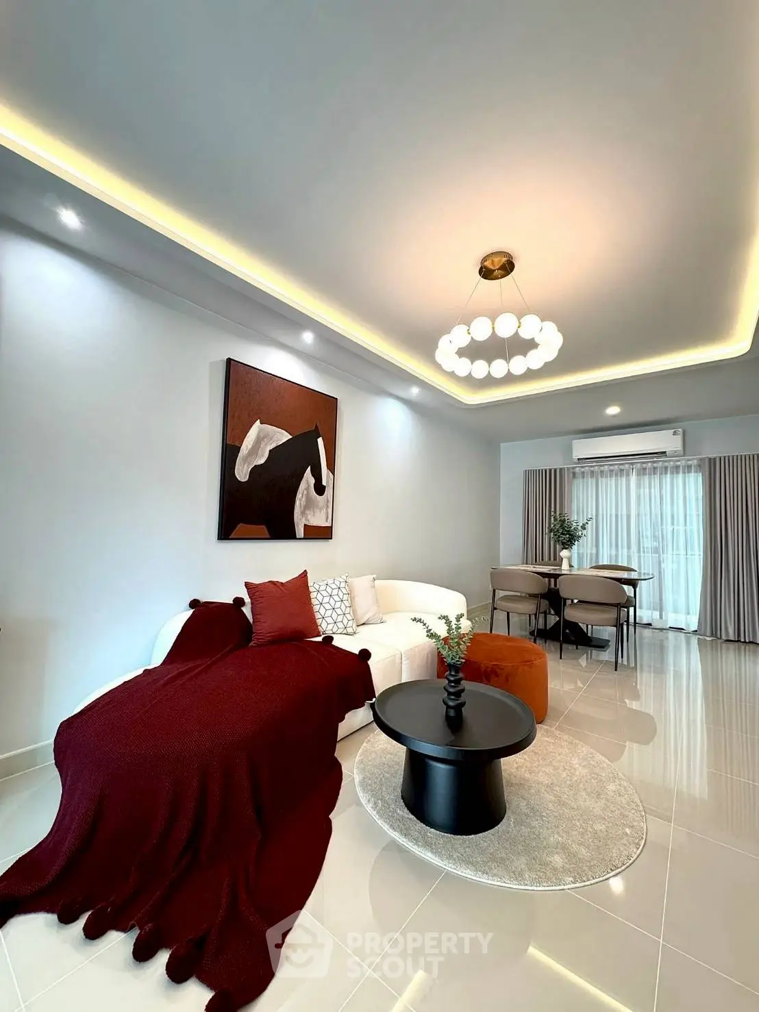 Modern living room with elegant decor and stylish lighting, featuring a cozy sofa and chic dining area.