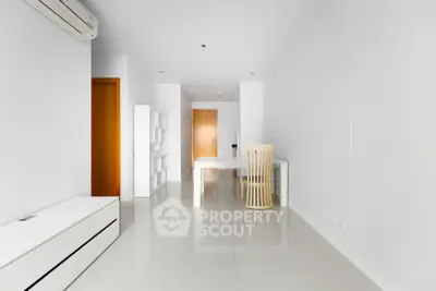 Modern minimalist interior with sleek white furniture and glossy tiled flooring, showcasing a bright and airy living space.