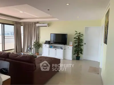 Spacious living room with modern decor and large windows offering ample natural light.