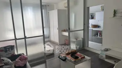 Modern studio apartment with sliding glass doors and minimalist decor
