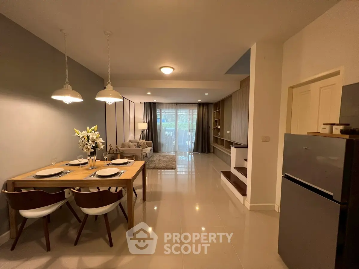 Spacious open-plan living and dining area with modern decor and natural light.