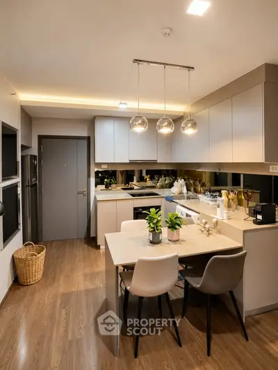 Modern kitchen with sleek cabinetry and stylish dining area in a contemporary apartment.
