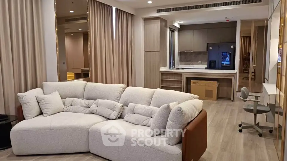 Spacious modern living room with cozy sectional sofa and open kitchen layout