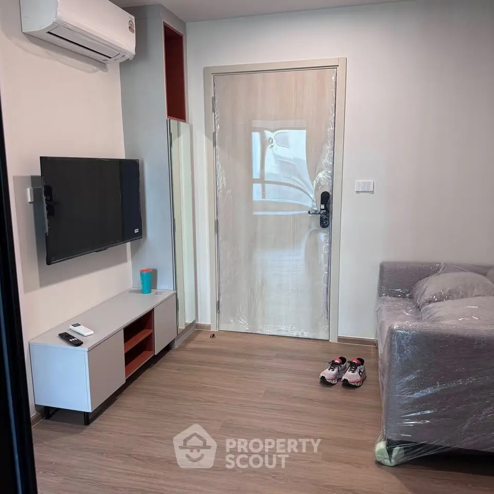 Modern living room with sleek TV setup and cozy sofa, perfect for relaxation.