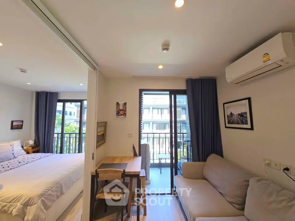 Modern apartment interior with cozy living room, bedroom, and balcony view.