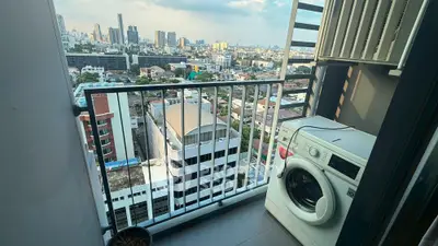 Stunning city view from a high-rise balcony with washing machine