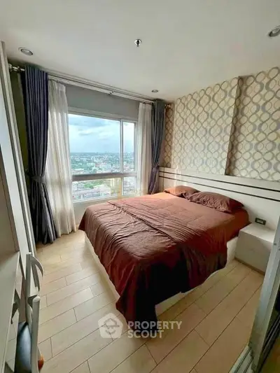 Cozy bedroom with city view, modern decor, and ample natural light in high-rise apartment.