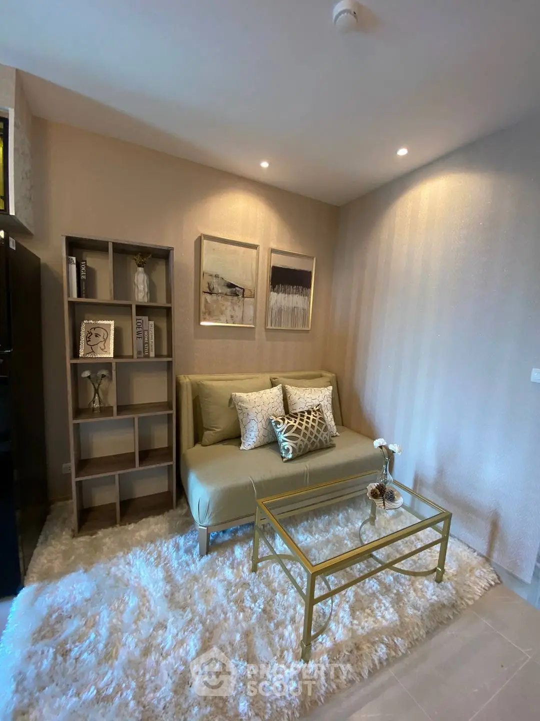 Cozy living room with modern decor and plush rug, perfect for relaxation.